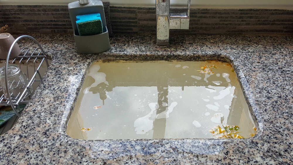 standing water in clogged kitchen sink